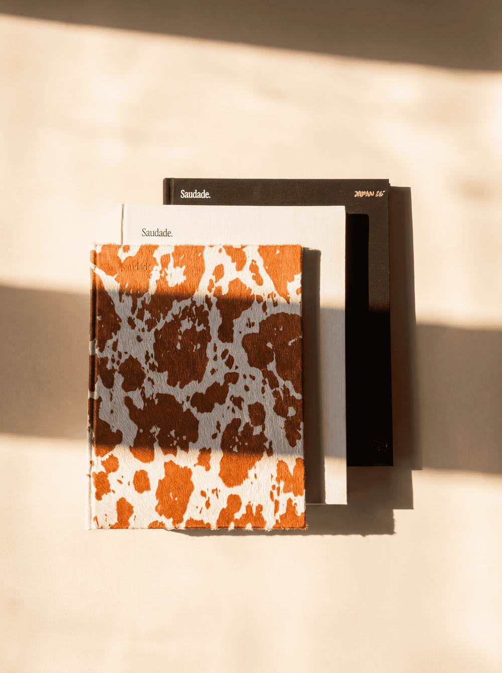 Saudade photo book covers — linen, leather and cowhide options with gold foil stamping